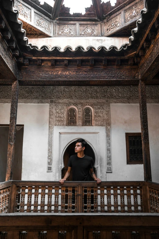 a man standing on the balcony of a building