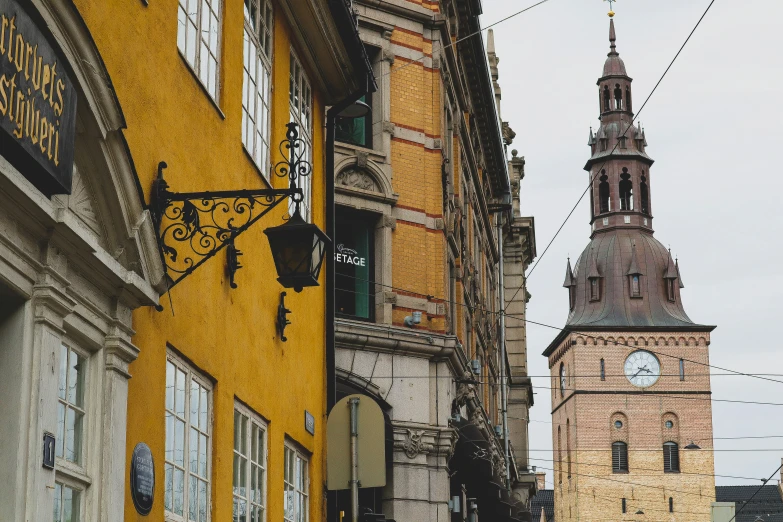 there is a large yellow building near some small buildings