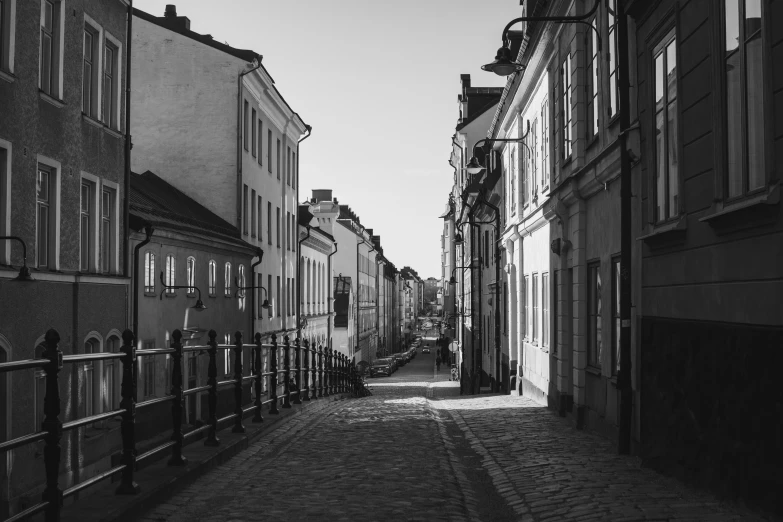 old - fashioned buildings line the street, as pedestrians pass by