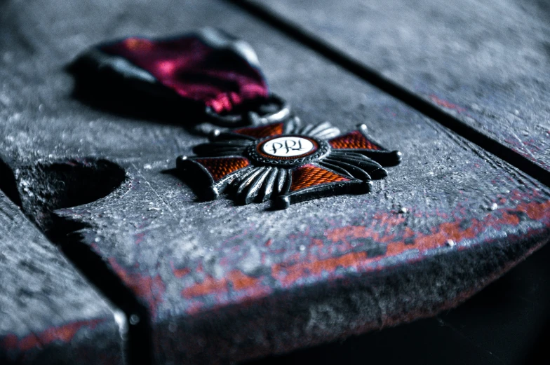 a close - up po of an old medal on a piece of wood