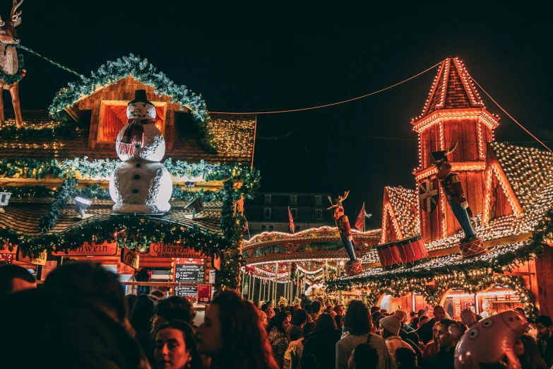 people looking at christmas lights on houses and trees