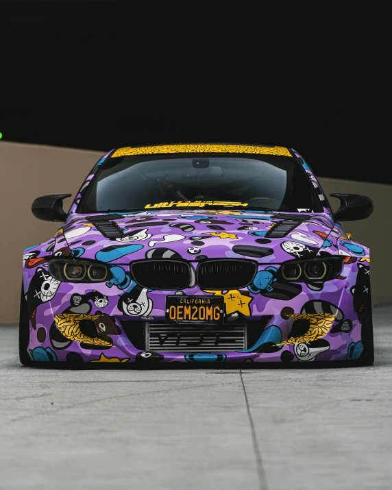 a purple car with various designs sitting outside