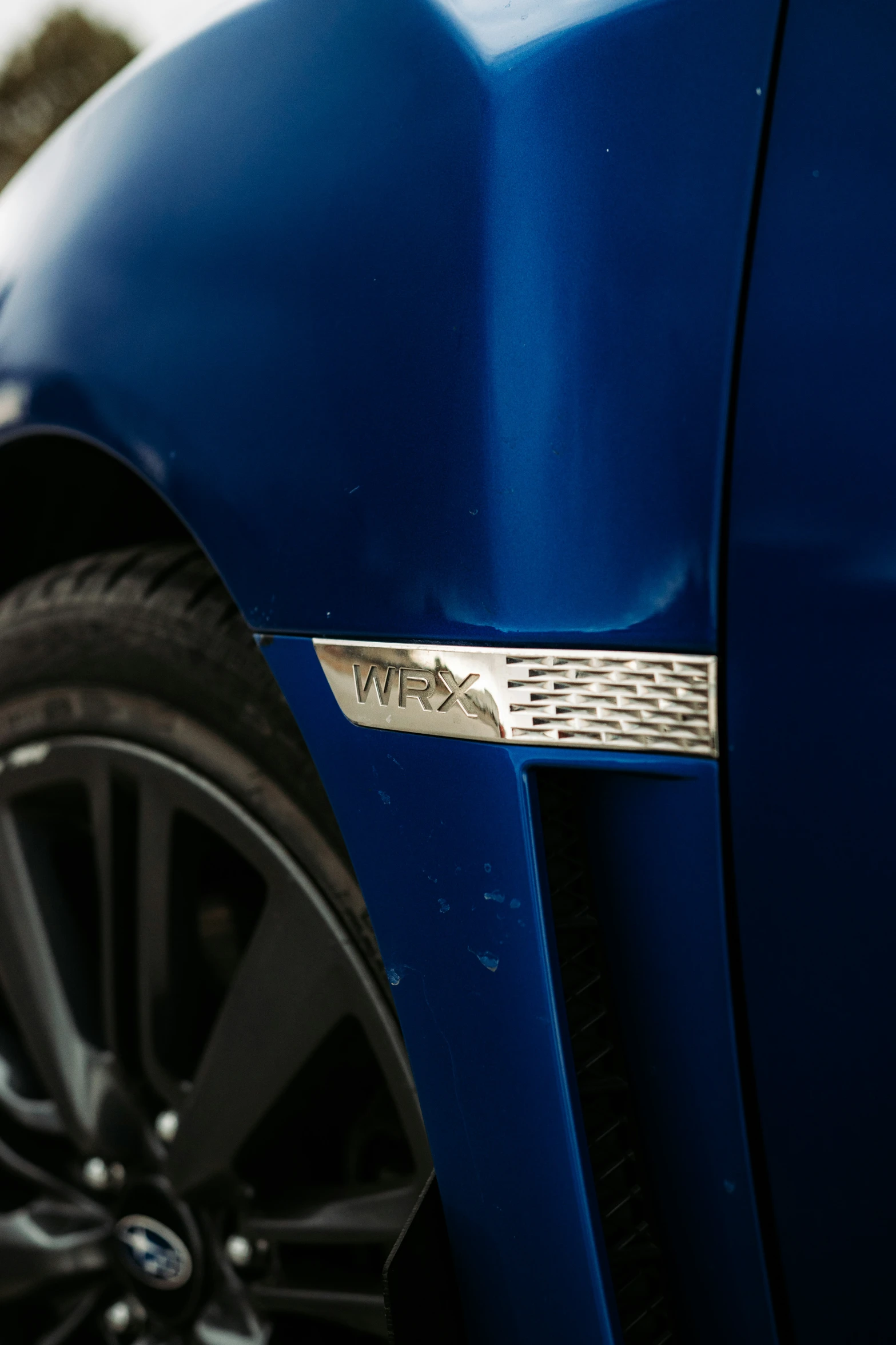 the front tire and emblem of a car