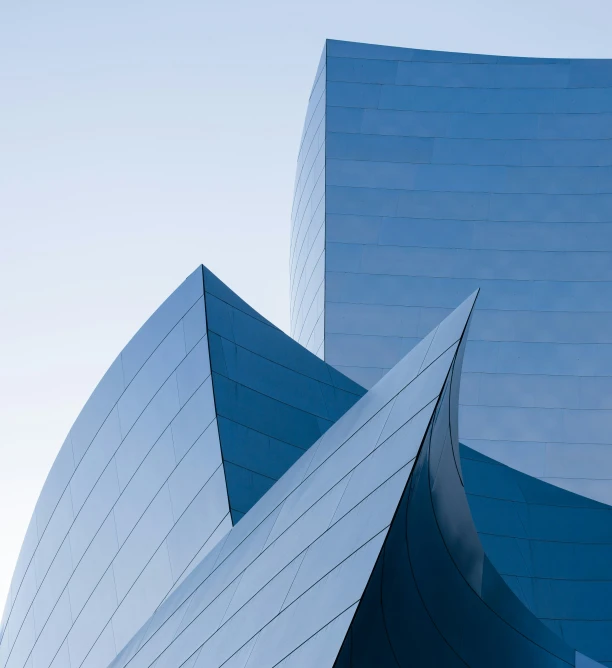 the building is designed like a cone - shaped blue structure