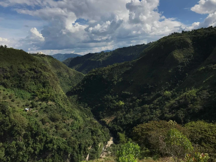 a hillside with several green hills in the background