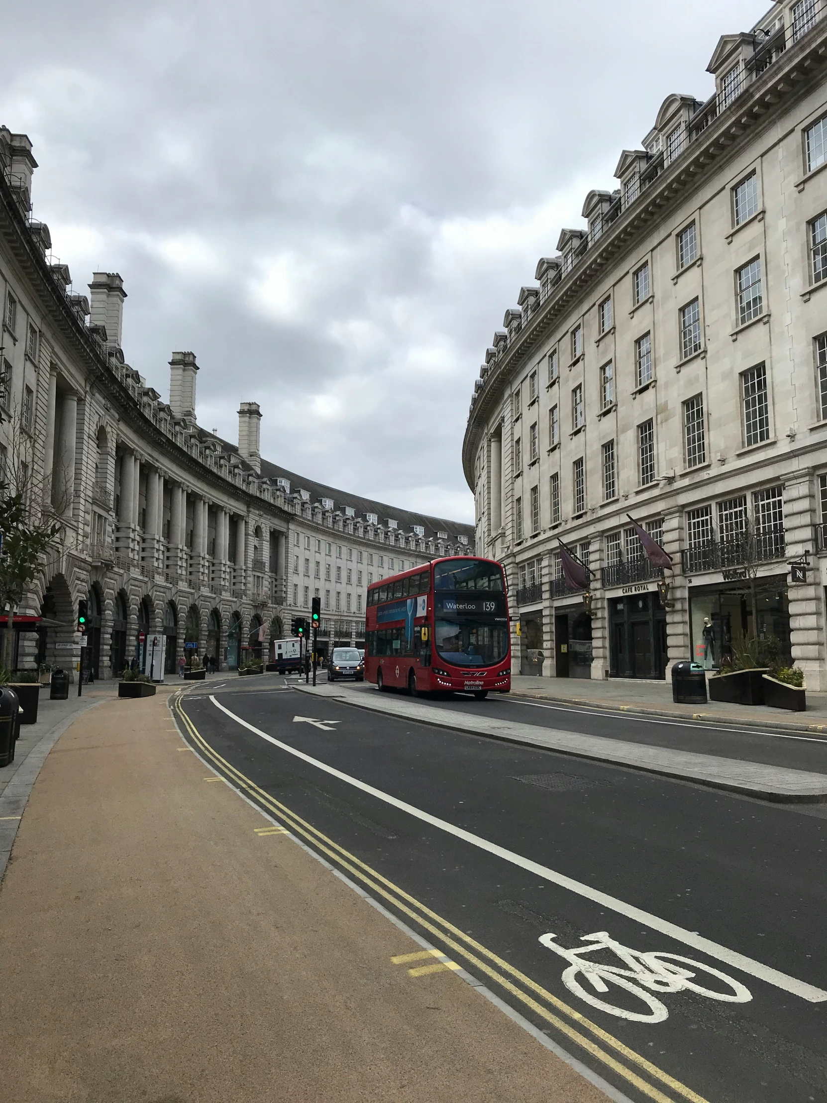 a red double deck bus driving down a street