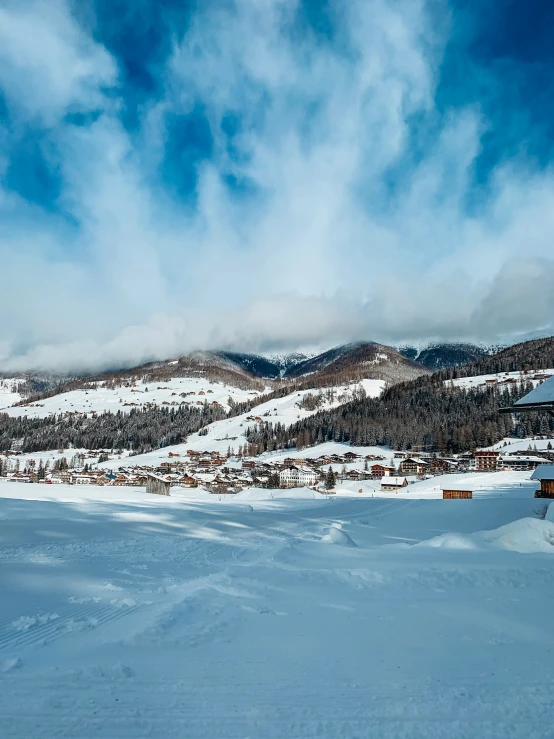 a person is standing on a snowy hill with some skis