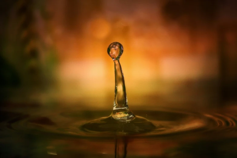 a close up view of a water drop that looks like it's about to fall