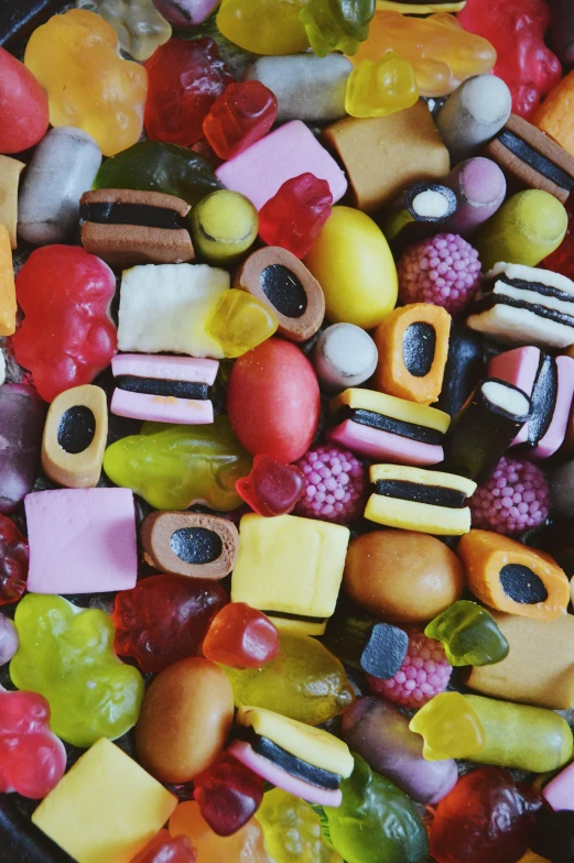 a black pan filled with lots of different kinds of candies