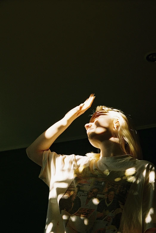 a woman is standing outside and looking into the air