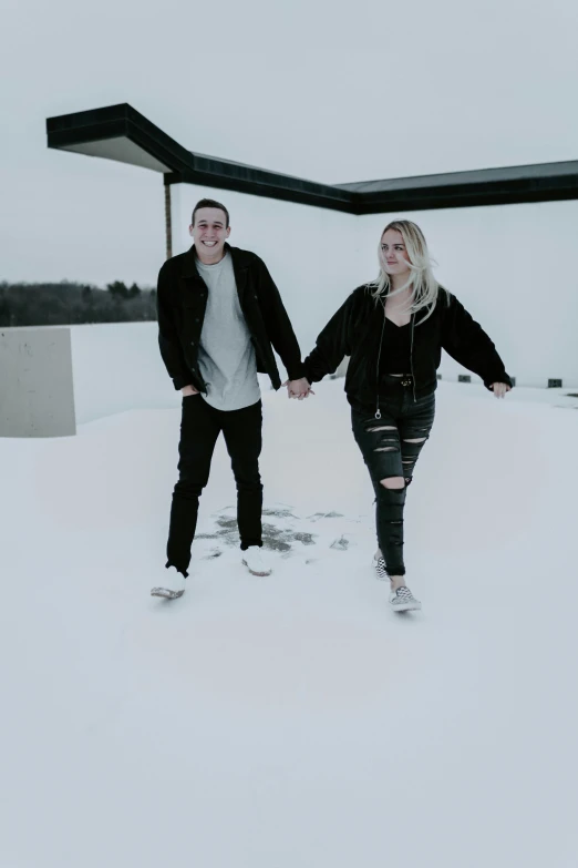 a couple walking down a snow covered street