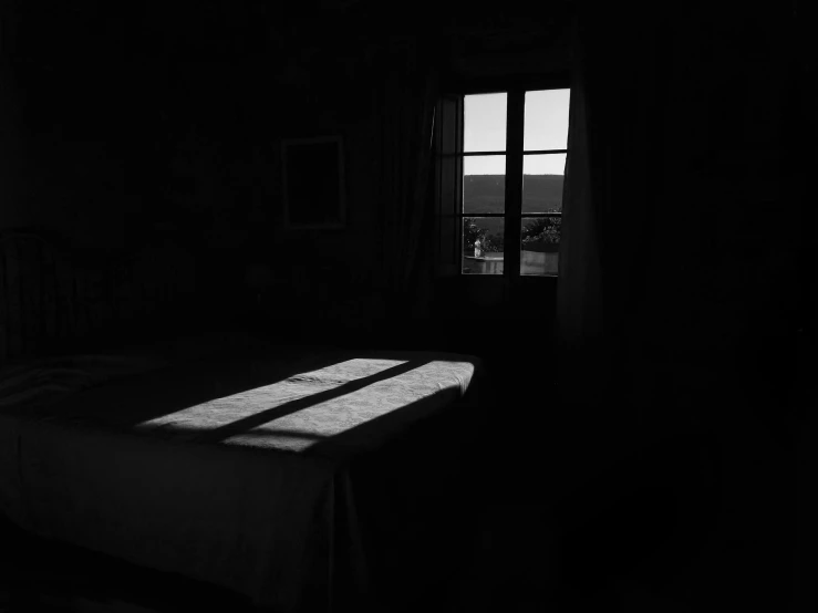 a window that is next to a bed in a room