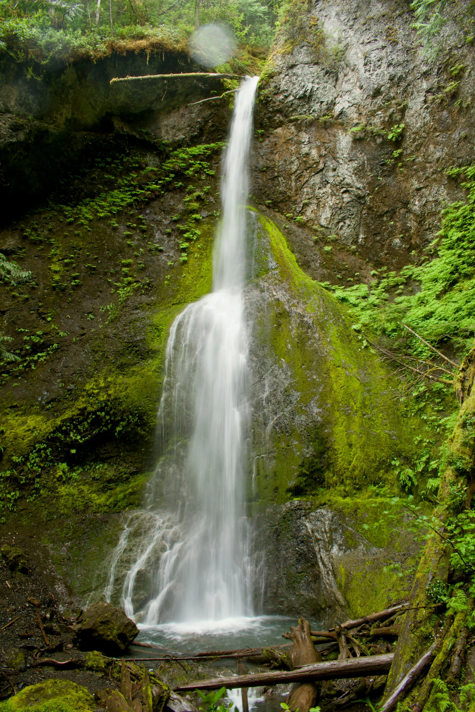 water pouring over rocks into a small waterfall