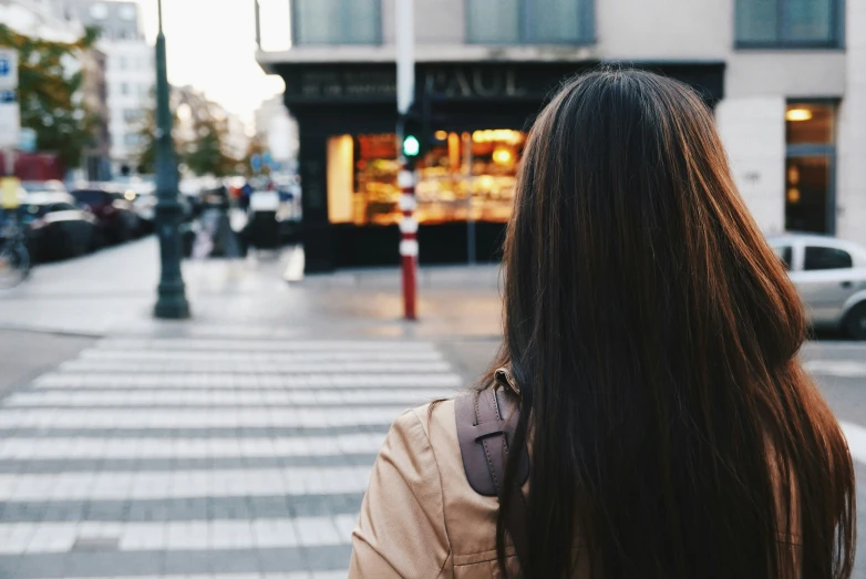 a woman with long black hair in the city