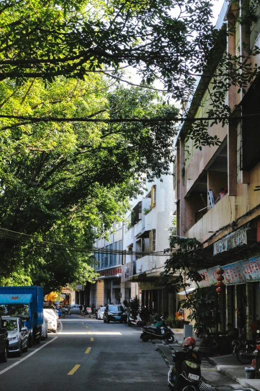 people on scooters on a narrow city street