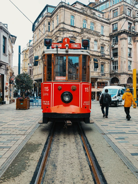 an old fashioned streetcar riding down a city street