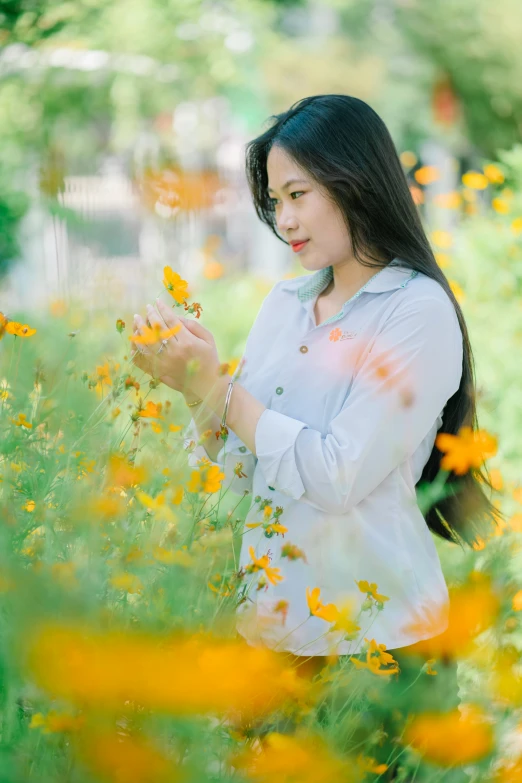 a  holds some flowers in her hands