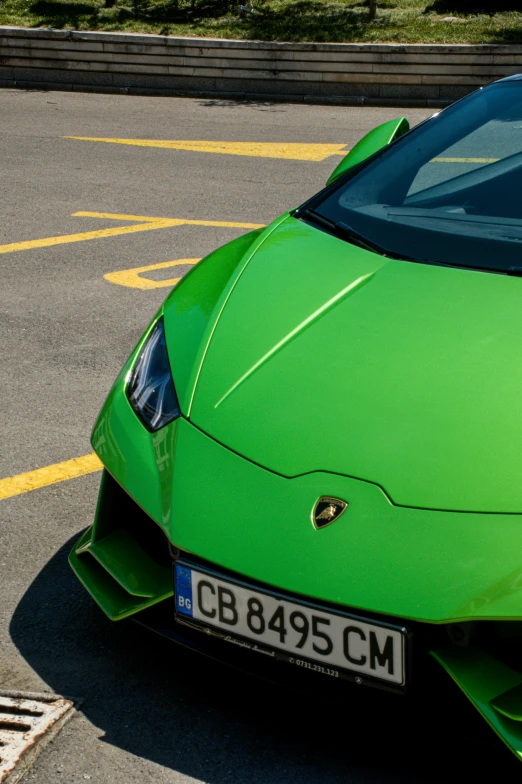 green lamb sports car with chrome accents parked in a parking lot