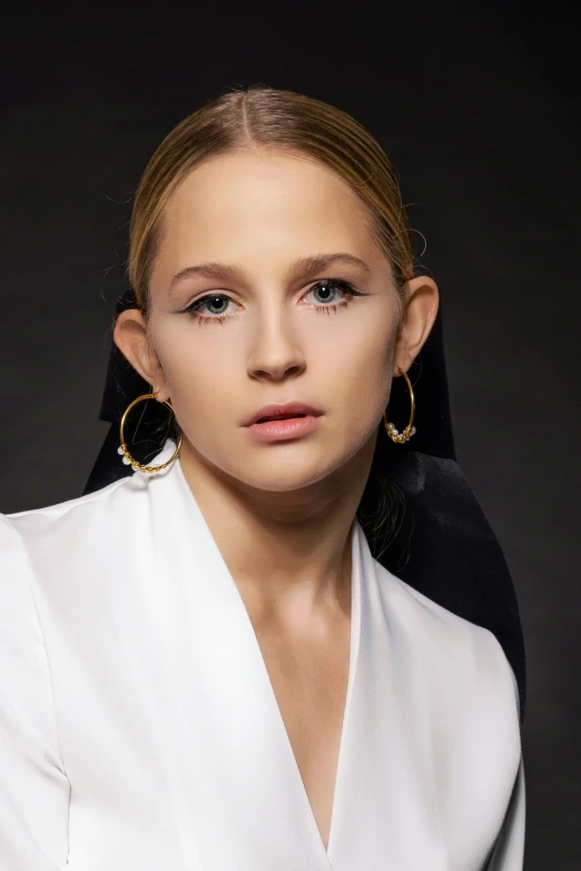 a model wears large gold hoop earrings