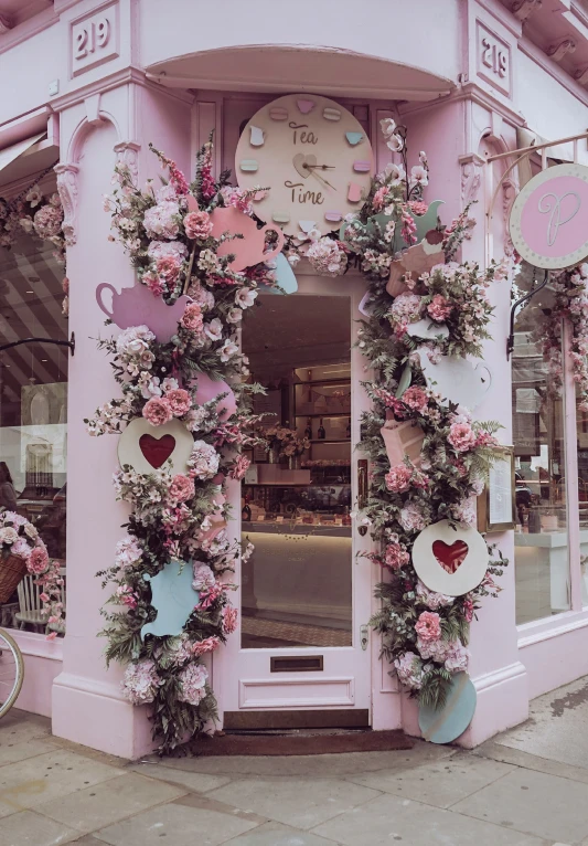 a building decorated with roses, hearts, and cupcakes