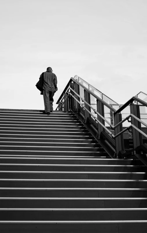 a black and white po of a man on an escalator