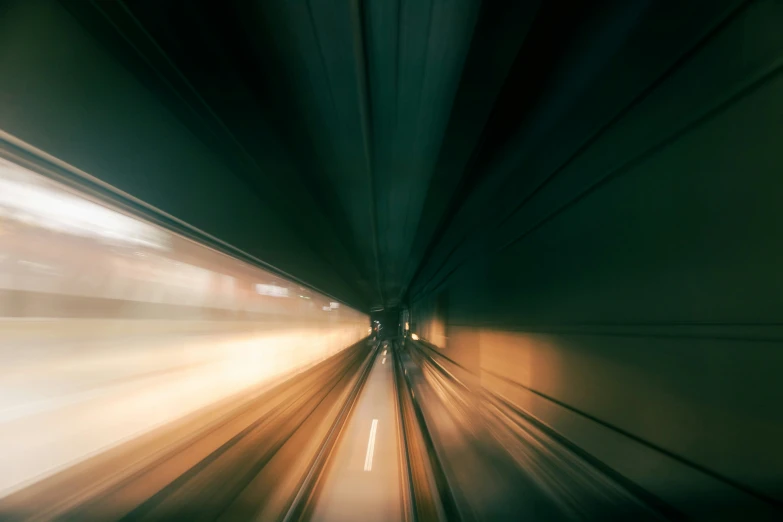 a blurry po of a train moving through the tunnel