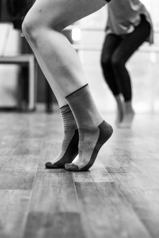 two dancers with knee socks performing on a dance floor