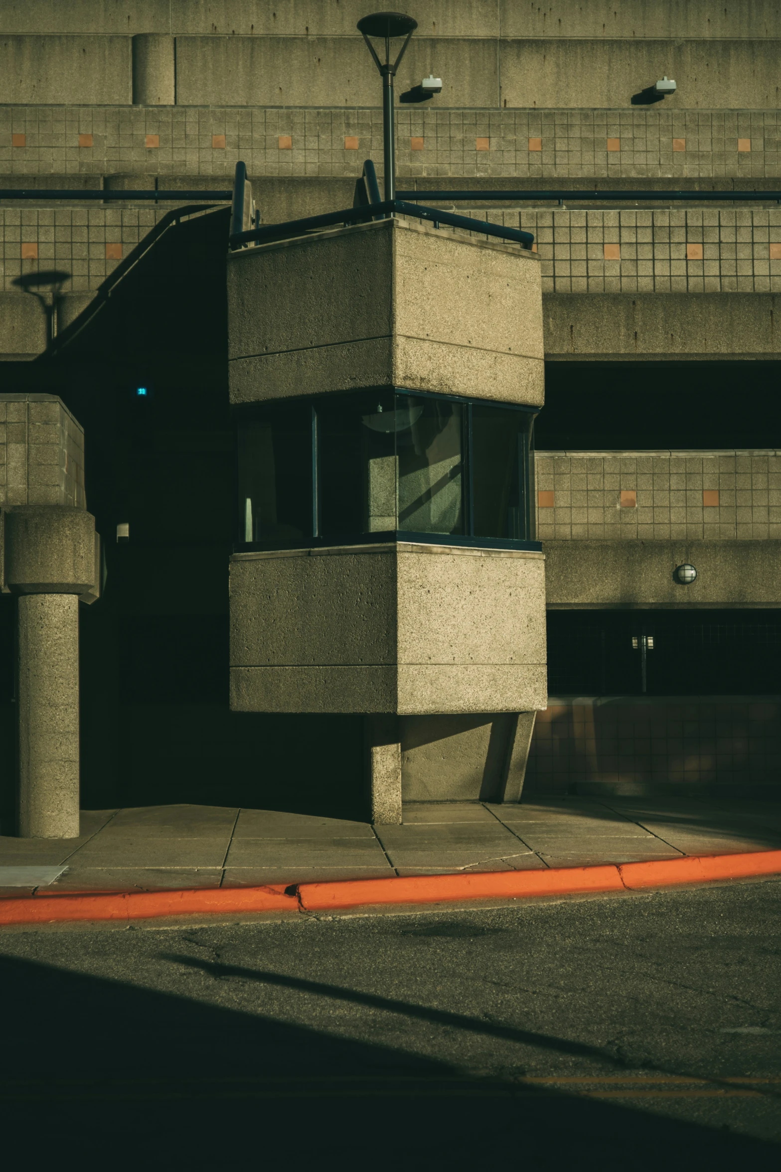 a concrete building with a street light on top