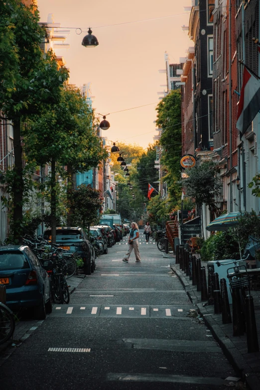 a lady walking on the side walk in an urban area