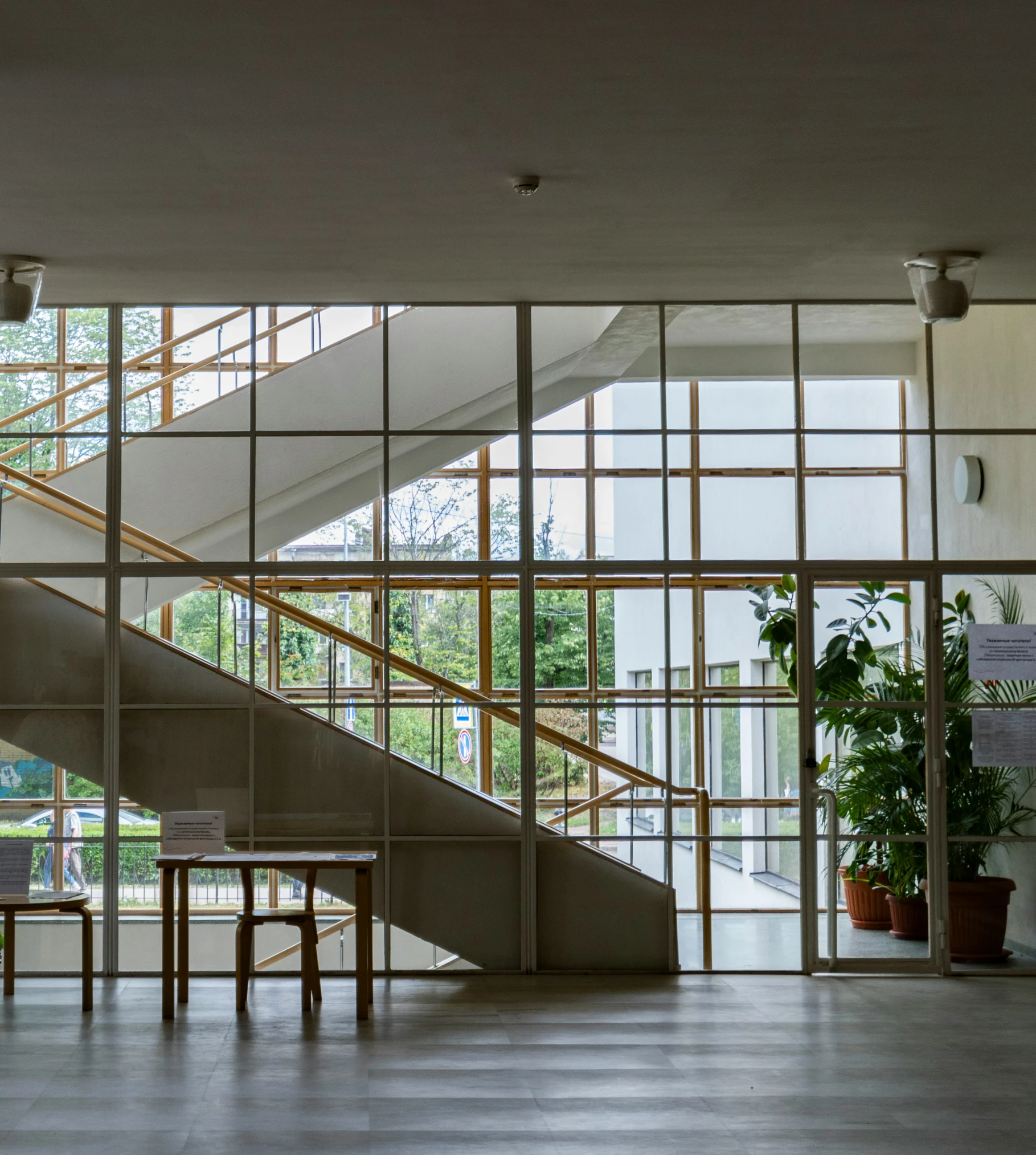 a staircase with glass walls is seen through the hallway