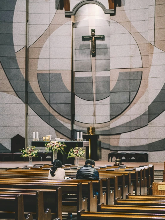 a man sleeps inside a church in front of pews