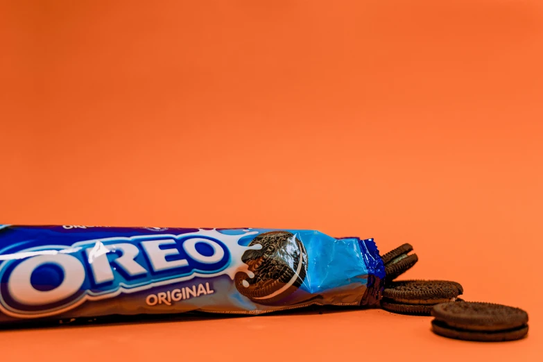 a bag of oreo cookies on an orange background