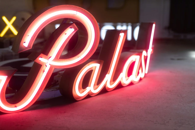 a sign for palas that is lit up with neon lights