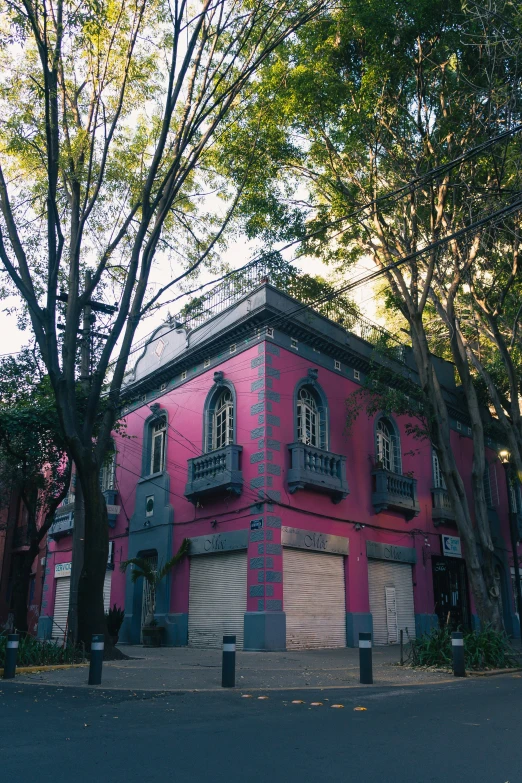 an old building with a large window and shutters in a city