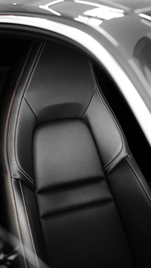 the black interior of a car with white stitching