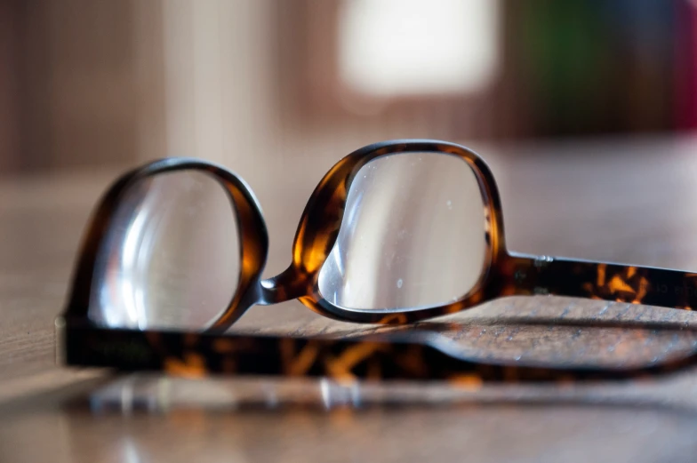 a pair of glasses are laying on the table