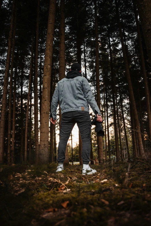 a man standing in the middle of a forest