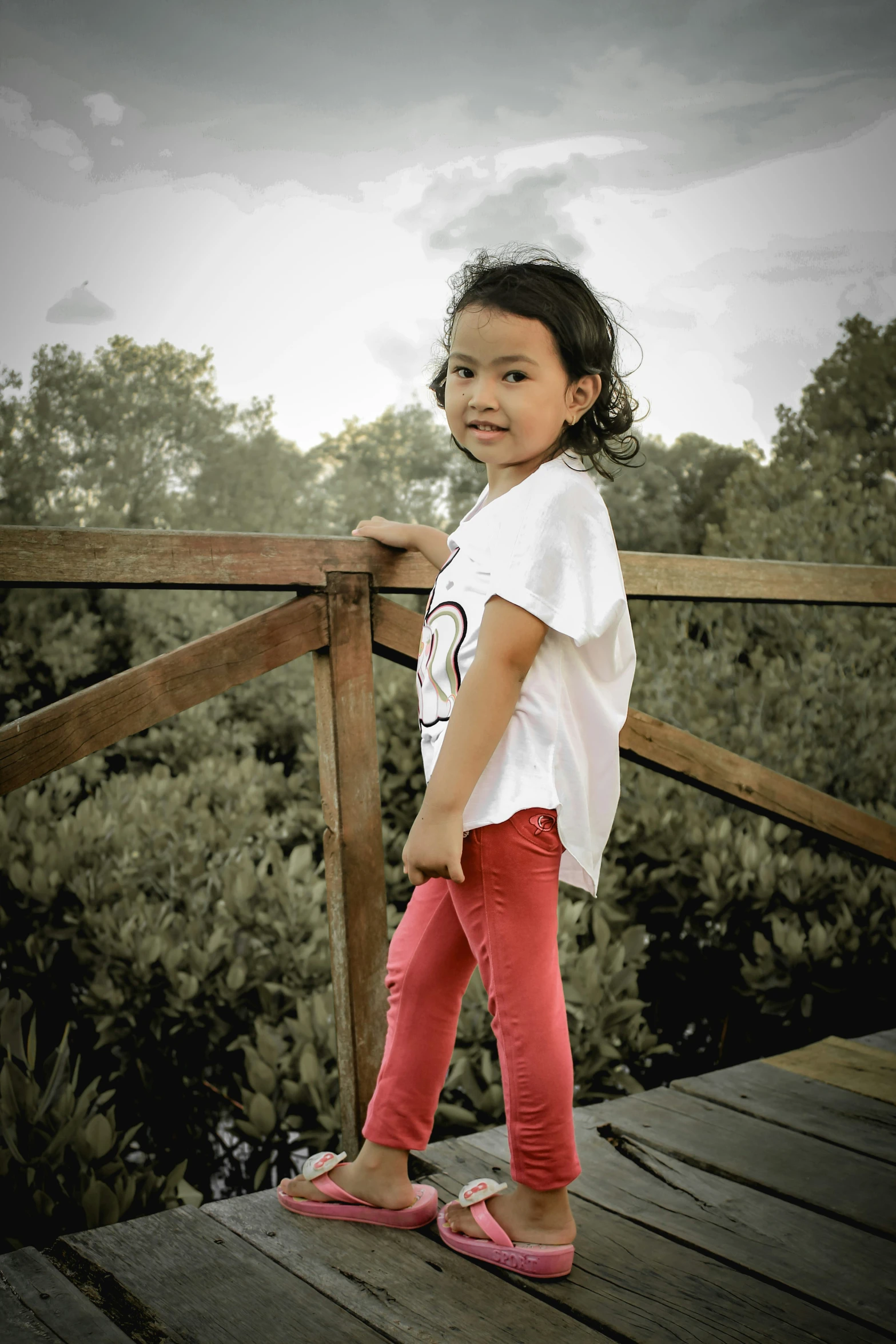 little asian girl on the pier by herself