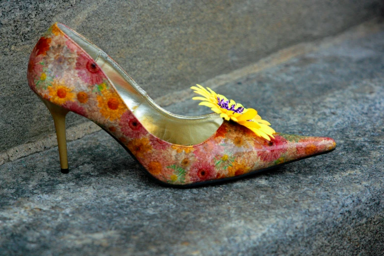 a pair of high heels with a flower decoration