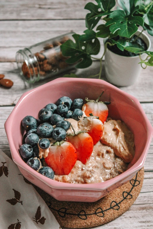 an oatmeal with berries and almonds on top