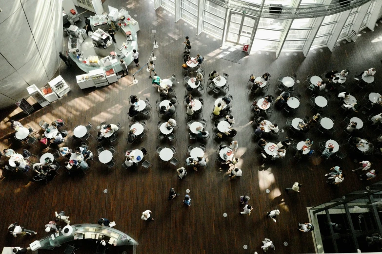 an overhead view of people sitting and walking in a building