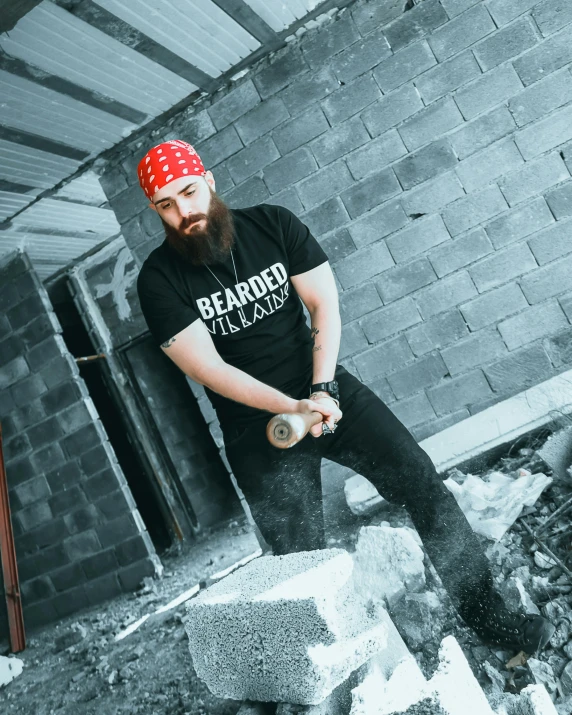 man with a beard holding a baseball in his hand