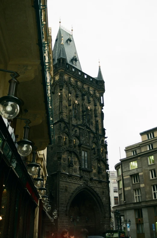 a very old clock tower with an ornate stone building behind it