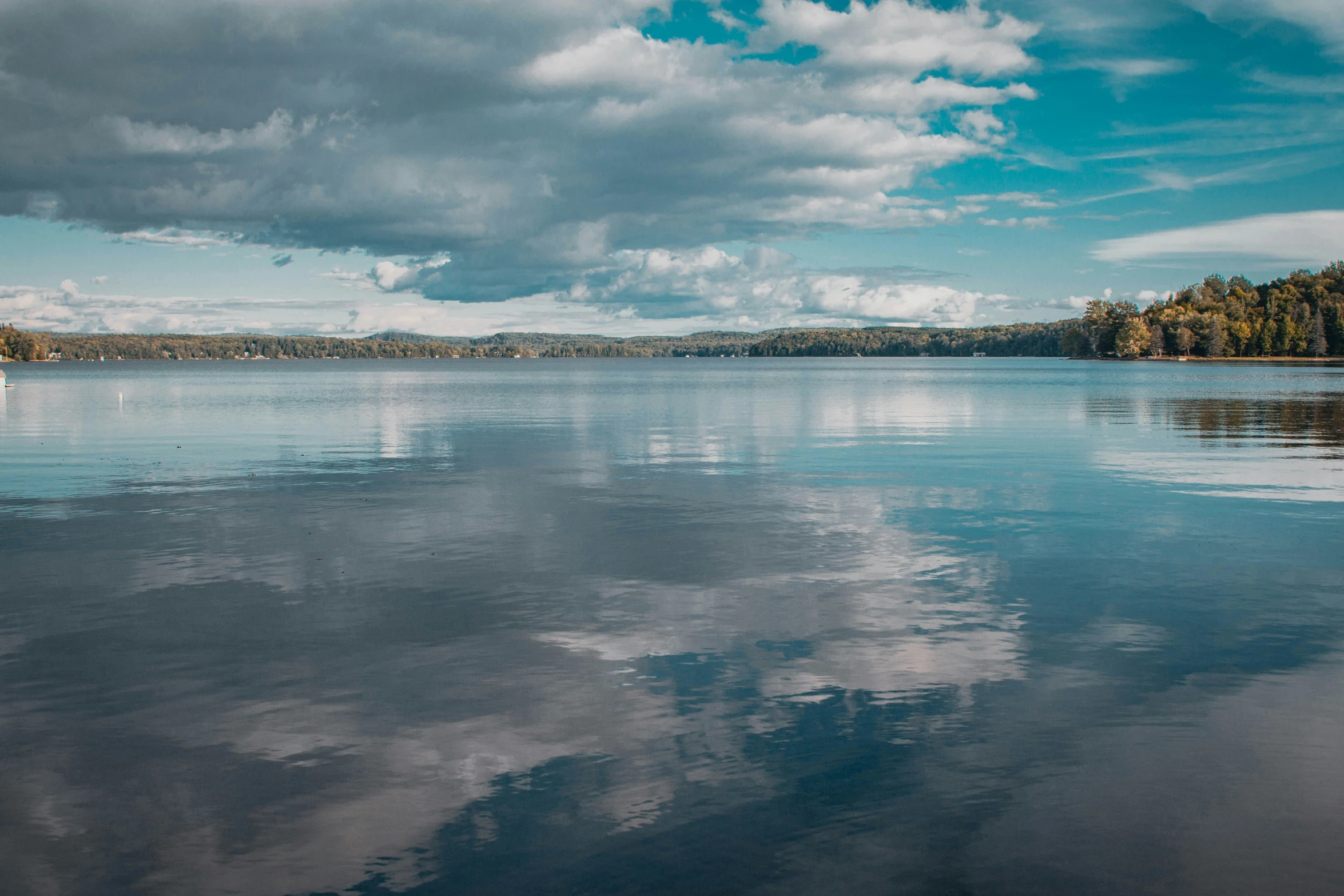 a lake with a boat in the distance