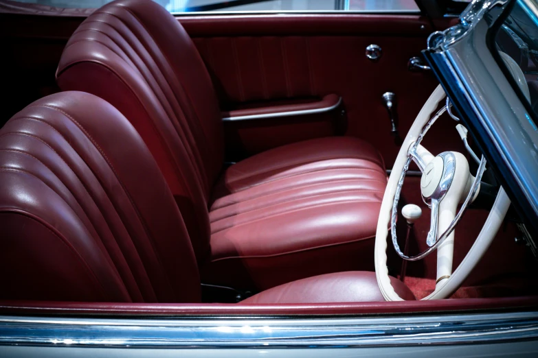 an interior view of an old car with red leather