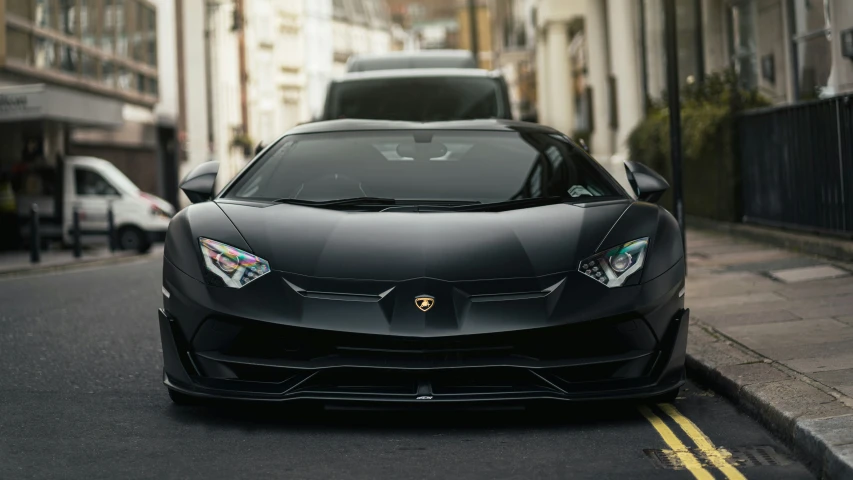 the front view of black sports car parked on the street