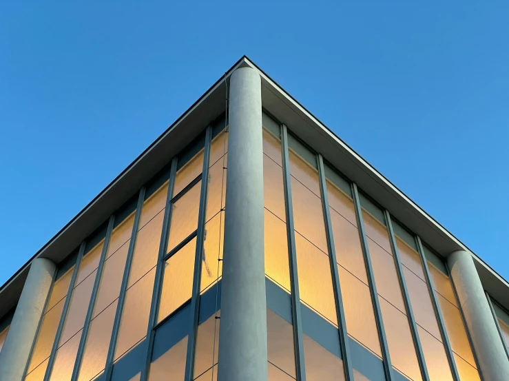 the corner of an office building under a blue sky