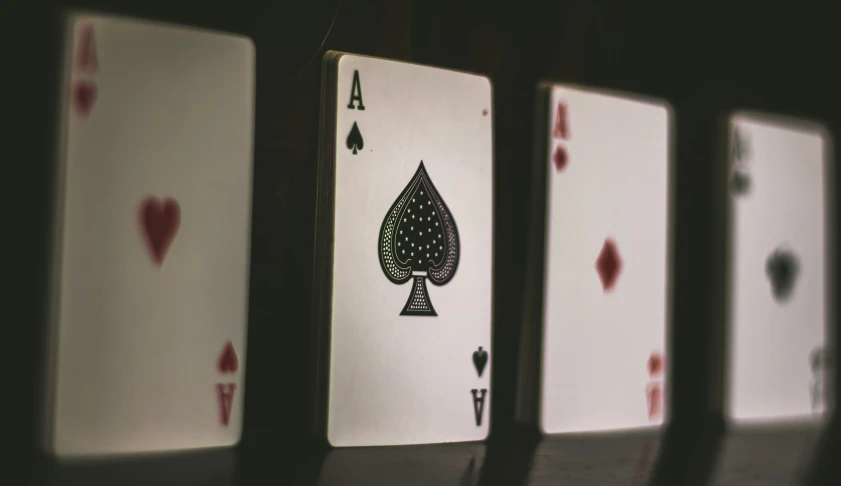 five ace playing cards lined up against each other