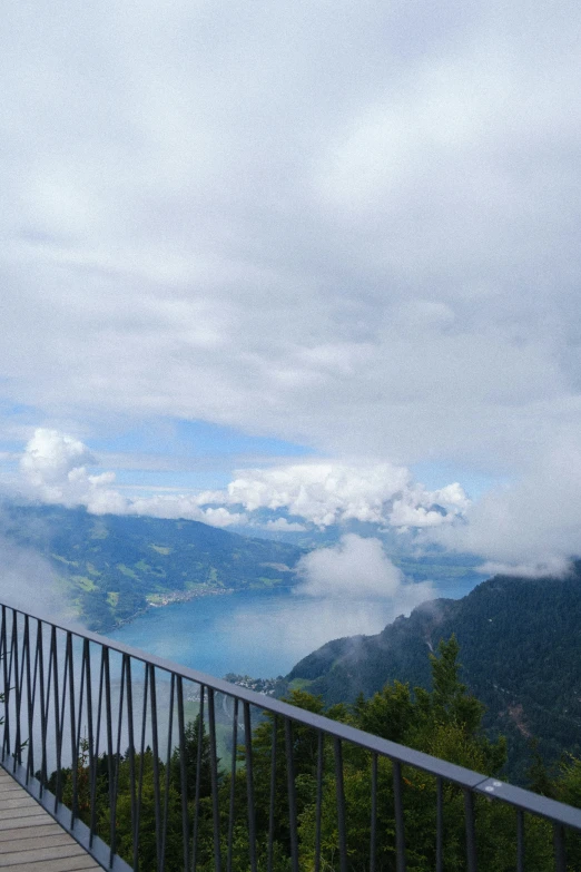 the woman is standing alone on the mountain side