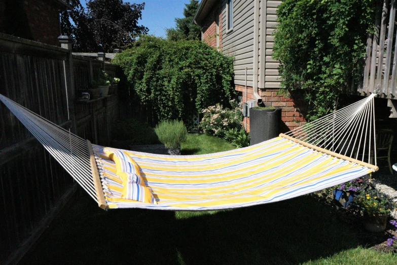 a hammock on a patio with green grass